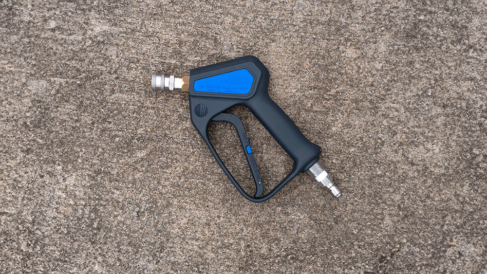 Black and blue pressure washer gun on a concrete surface