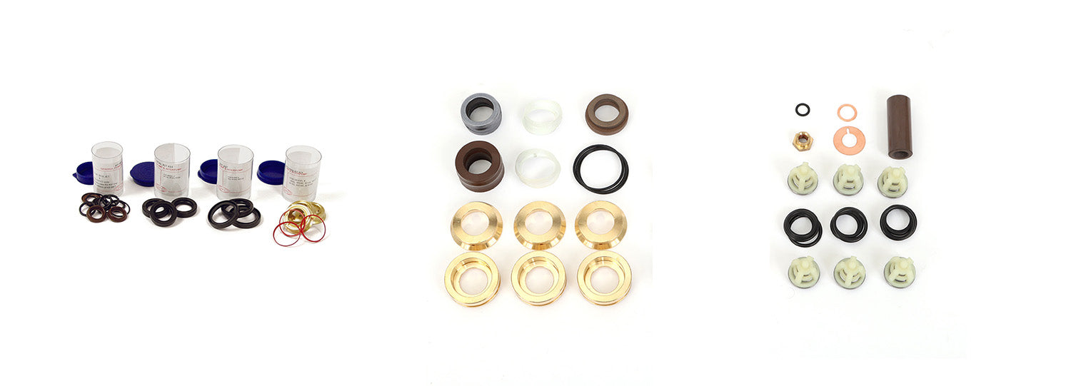 Set of small bushings, o-rings and valves on a white background